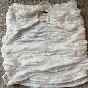 White Ruffled Skirt (or shirt) with gold buckle design.